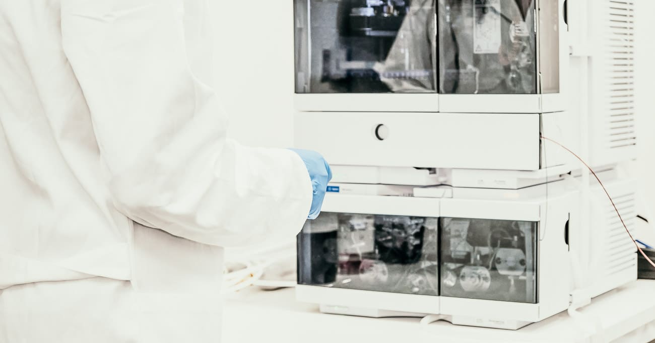 A scientist getting ready to load samples onto a High Performance Liquid Chromatography (HPLC) instrument. This instrument is commonly used in analytical labs to test functional mushrooms, like reishi.